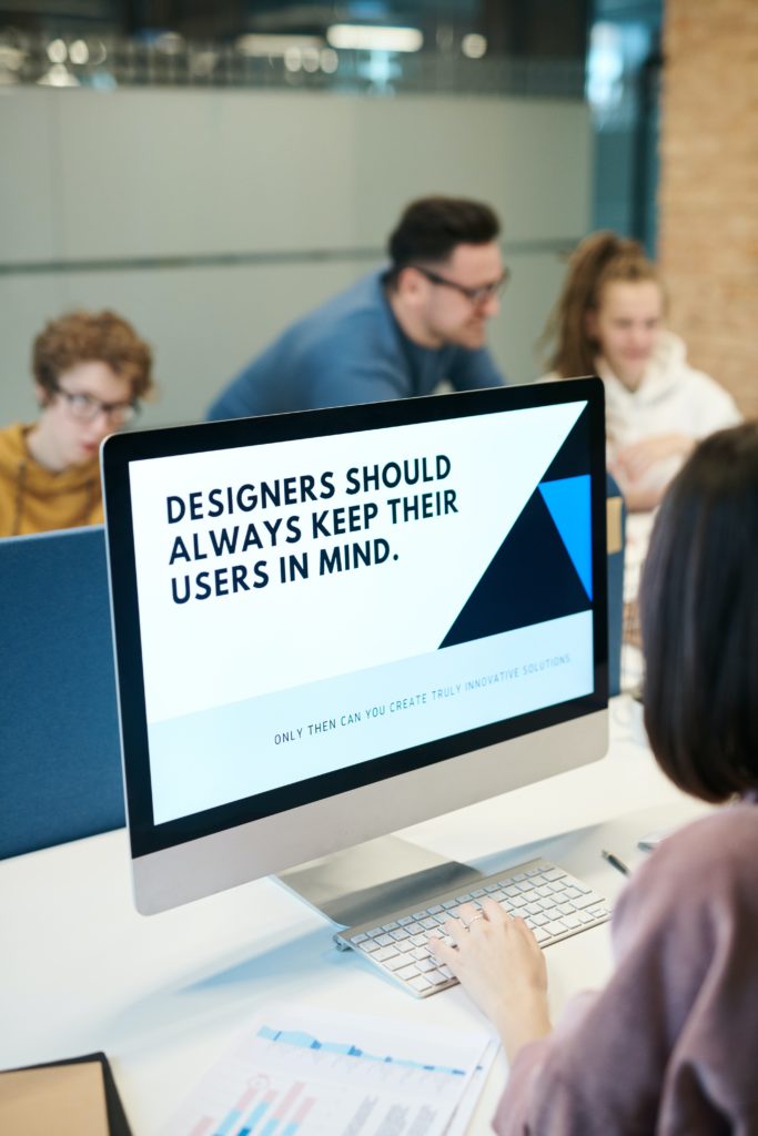 iMac with the message: "Designers should always keep their users in mind." on the screen.
